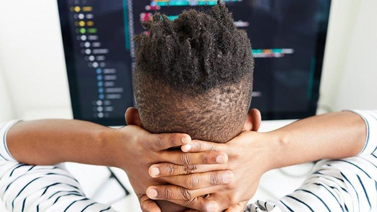man sitting back deciding whether to outsource web design or not